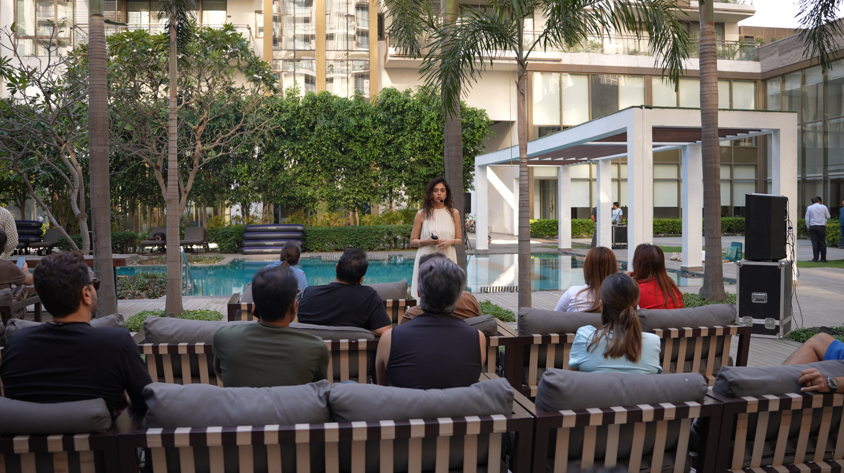The Sanctuary Awaits — guests gathered by the pool at dusk