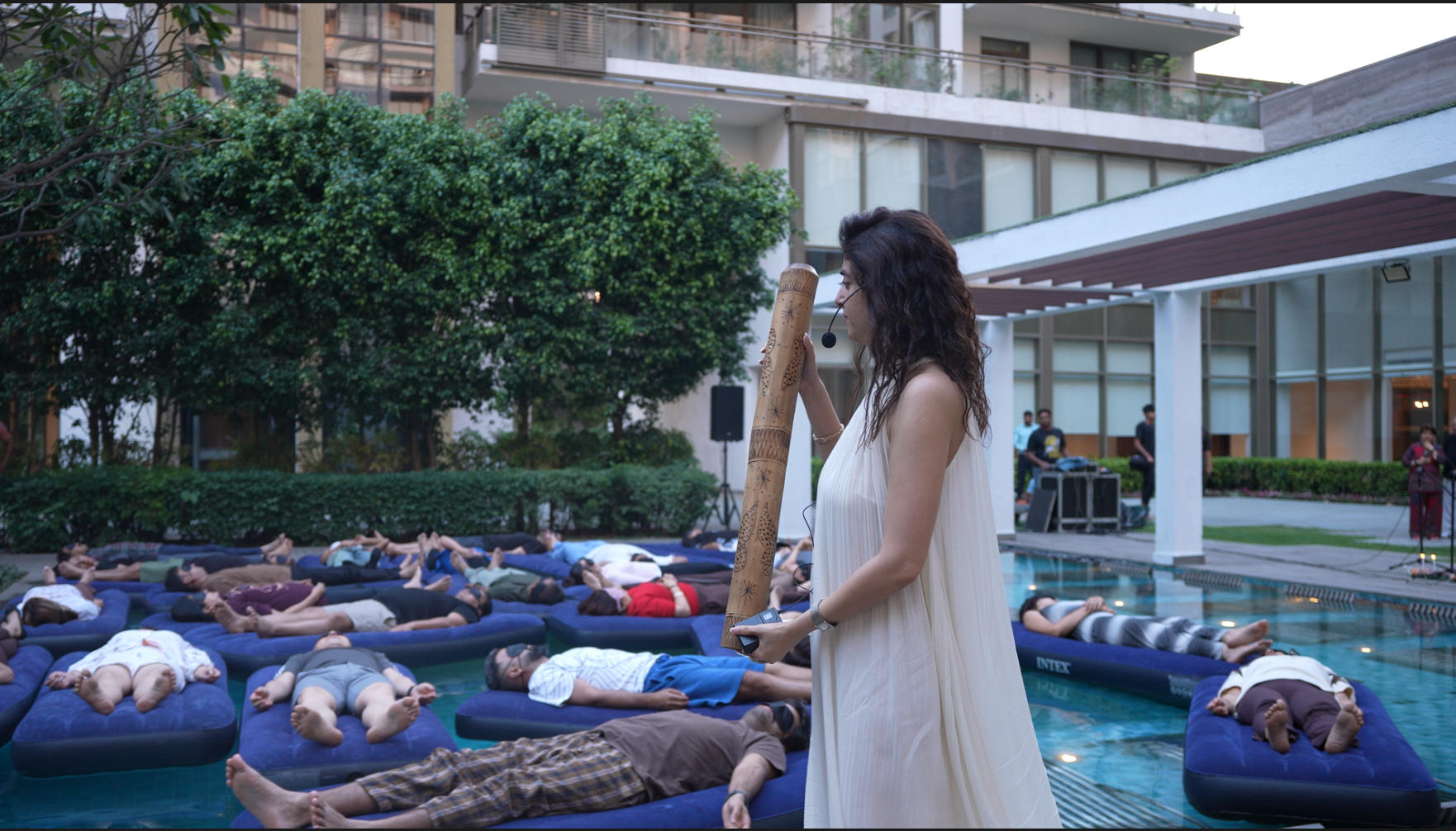 Participants on floating mats during an aqua sound session