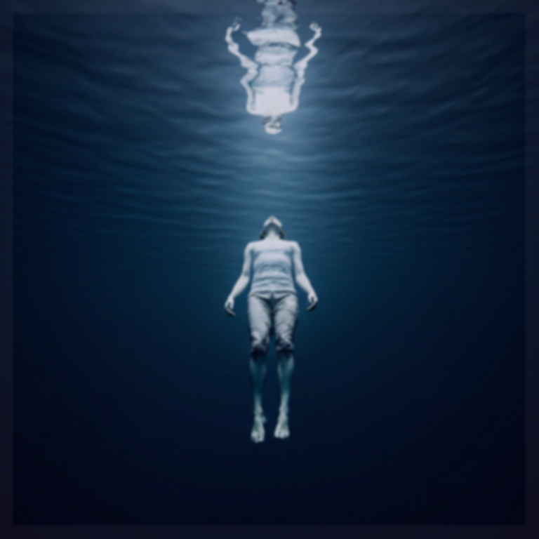 Figure floating in deep water, lit from above